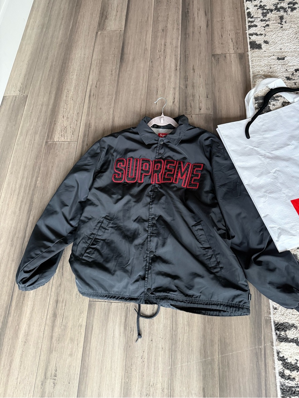 Supreme Black Coach Jacket with Red Embroidered Logo